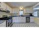 Kitchen with stainless steel appliances and white cabinets at 5762 Lilburn Stone Mountain Rd, Stone Mountain, GA 30087