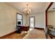 Home office with wood desk, window, and chandelier at 5762 Lilburn Stone Mountain Rd, Stone Mountain, GA 30087