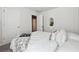 Bedroom with white bedding and decorative mirror at 3948 Lake Manor Way, Atlanta, GA 30349