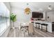 Dining area with glass table, light-colored chairs, and a modern chandelier at 3948 Lake Manor Way, Atlanta, GA 30349