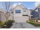 Two-story house with light beige siding, a white garage door, and a neatly landscaped lawn at 3948 Lake Manor Way, Atlanta, GA 30349