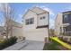 Two-story house with light beige siding, a white garage door, and a neatly landscaped lawn at 3948 Lake Manor Way, Atlanta, GA 30349