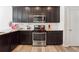 Kitchen with dark cabinets, granite countertops, and stainless steel appliances at 3948 Lake Manor Way, Atlanta, GA 30349