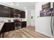 Kitchen features dark cabinetry, granite countertops, and stainless steel appliances at 3948 Lake Manor Way, Atlanta, GA 30349