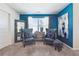 Sitting area with teal walls, comfortable armchairs, and large artwork at 3948 Lake Manor Way, Atlanta, GA 30349