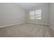 Spacious bedroom with neutral carpeting and large window at 509 Ajo Way, Dallas, GA 30157