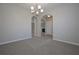 Dining room with carpet, chandelier, and archways at 509 Ajo Way, Dallas, GA 30157