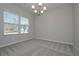 Bright dining room with carpet, chandelier, and window at 509 Ajo Way, Dallas, GA 30157