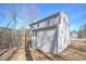 Rear view of house showcasing deck and wooded setting at 509 Ajo Way, Dallas, GA 30157