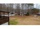 An aerial shot of this outdoor space, featuring the deck and backyard surrounded by lush, tall trees at 8255 Stonebrook Dr, Cumming, GA 30040