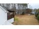 Expansive backyard with wooden deck, perfect for outdoor entertaining and relaxation with natural landscaping at 8255 Stonebrook Dr, Cumming, GA 30040