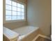 Bathroom featuring a large soaking tub and window at 8255 Stonebrook Dr, Cumming, GA 30040