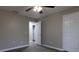 Light-filled bedroom featuring hardwood floors, modern ceiling fan, and neutral paint at 8255 Stonebrook Dr, Cumming, GA 30040