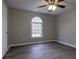 Bedroom with arched window and ceiling fan at 8255 Stonebrook Dr, Cumming, GA 30040