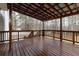 An open-air wooden deck provides a relaxing outdoor space, surrounded by the lush greenery of trees at 8255 Stonebrook Dr, Cumming, GA 30040