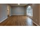 Dining room showcasing beautiful hardwood floors and a large arched window with a view to the outside at 8255 Stonebrook Dr, Cumming, GA 30040