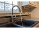 Close up view of the kitchen sink with brushed nickel faucet, tile backsplash, and view to the outdoors at 8255 Stonebrook Dr, Cumming, GA 30040