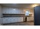 Kitchen with stainless steel appliances, white cabinets, a view to the dining room and dark countertops at 8255 Stonebrook Dr, Cumming, GA 30040