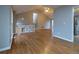 Spacious living room featuring hardwood floors, vaulted ceiling, large windows and entrance to the kitchen area at 8255 Stonebrook Dr, Cumming, GA 30040