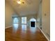 Open living room featuring hardwood floors, a vaulted ceiling, large windows, and a staircase to the upper level at 8255 Stonebrook Dr, Cumming, GA 30040