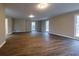 Spacious living room with wood floors, with neutral wall paint and plenty of natural light at 8255 Stonebrook Dr, Cumming, GA 30040