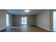 Well-lit living room featuring sliding glass doors leading to the backyard at 8255 Stonebrook Dr, Cumming, GA 30040