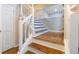 Elegant staircase with white railings and wood flooring at 8255 Stonebrook Dr, Cumming, GA 30040