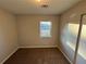 Small bedroom with brown carpet and a window at 1851 Irwin Bridge Nw Rd, Conyers, GA 30012