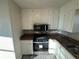 View of kitchen with stainless steel appliances and brown countertops at 1851 Irwin Bridge Nw Rd, Conyers, GA 30012