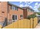 Brick building exterior with a wooden fence and patio at 6520 Roswell Rd # 106, Atlanta, GA 30328