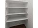 Empty pantry with four shelves, offering ample storage space at 6520 Roswell Rd # 106, Atlanta, GA 30328