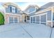 Spacious three-car garage attached to a brick-accented two story home with a concrete driveway at 4960 Shade Creek Xing, Cumming, GA 30028