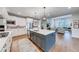 Open concept kitchen with island and view into the living room at 4960 Shade Creek Xing, Cumming, GA 30028