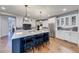 Modern kitchen with white cabinets, blue island, and quartz countertops at 4960 Shade Creek Xing, Cumming, GA 30028