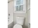 Clean bathroom with a white toilet and bathtub at 7270 Oswego Trl, Riverdale, GA 30296