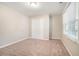 Well-lit bedroom with carpet and double door closet at 7270 Oswego Trl, Riverdale, GA 30296