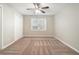 Spacious bedroom with ceiling fan, carpet, and double doors at 7270 Oswego Trl, Riverdale, GA 30296