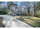 Ranch style home with a large yard and driveway at 7270 Oswego Trl, Riverdale, GA 30296