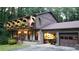 Two-story house with a brick garage and landscaping at 4567 Town Crier Sw Rd, Lilburn, GA 30047