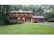 Two-story house with a brick garage and landscaping at 4567 Town Crier Sw Rd, Lilburn, GA 30047
