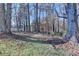 A beautifully wooded backyard offers a private and serene setting leading to the lake at 6460 Pine Ridge Cir, Cumming, GA 30041