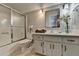 Bright bathroom featuring a shower-tub combo, decorative finishes, and neutral tones at 6460 Pine Ridge Cir, Cumming, GA 30041