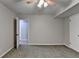 Simple, carpeted bedroom with an open door to hallway at 6460 Pine Ridge Cir, Cumming, GA 30041