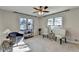 Serene bedroom with neutral tones, two windows, and a ceiling fan that invites relaxation and comfort at 6460 Pine Ridge Cir, Cumming, GA 30041