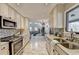 Bright and airy kitchen featuring white cabinets, granite countertops, and stainless steel appliances at 6460 Pine Ridge Cir, Cumming, GA 30041