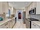 Well-equipped kitchen with stainless steel appliances, granite countertops, and a view of the dining area at 6460 Pine Ridge Cir, Cumming, GA 30041