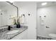 Contemporary bathroom with granite countertop, black fixtures, and patterned floor at 2371 Wingfoot Pl, Decatur, GA 30035