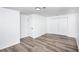 Bright bedroom with wood-look floors and double doors leading to a large closet at 2371 Wingfoot Pl, Decatur, GA 30035