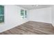 Well-lit bedroom featuring wood-look floors and two windows offering natural light at 2371 Wingfoot Pl, Decatur, GA 30035