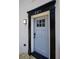 Stylish front door with black trim and updated light fixture at 2371 Wingfoot Pl, Decatur, GA 30035